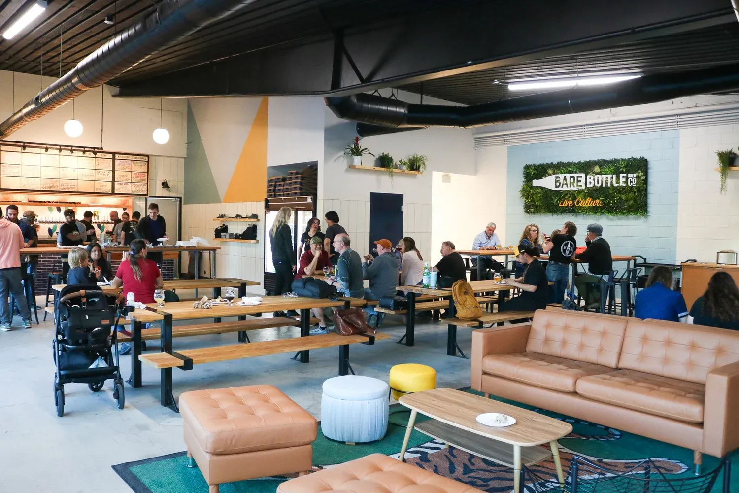 The main area of the Barebottle Walnut Creek taproom filled with people.